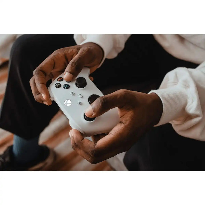 White xbox controller with black buttons and logo.